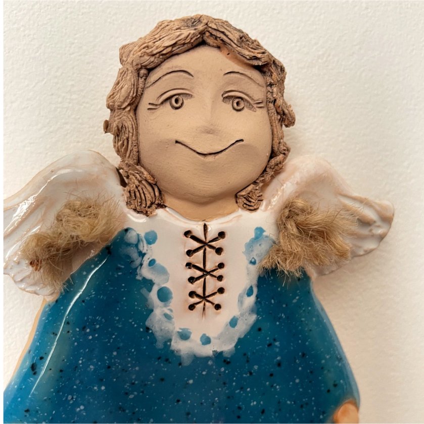 turquoise ceramic angel wall decor close up