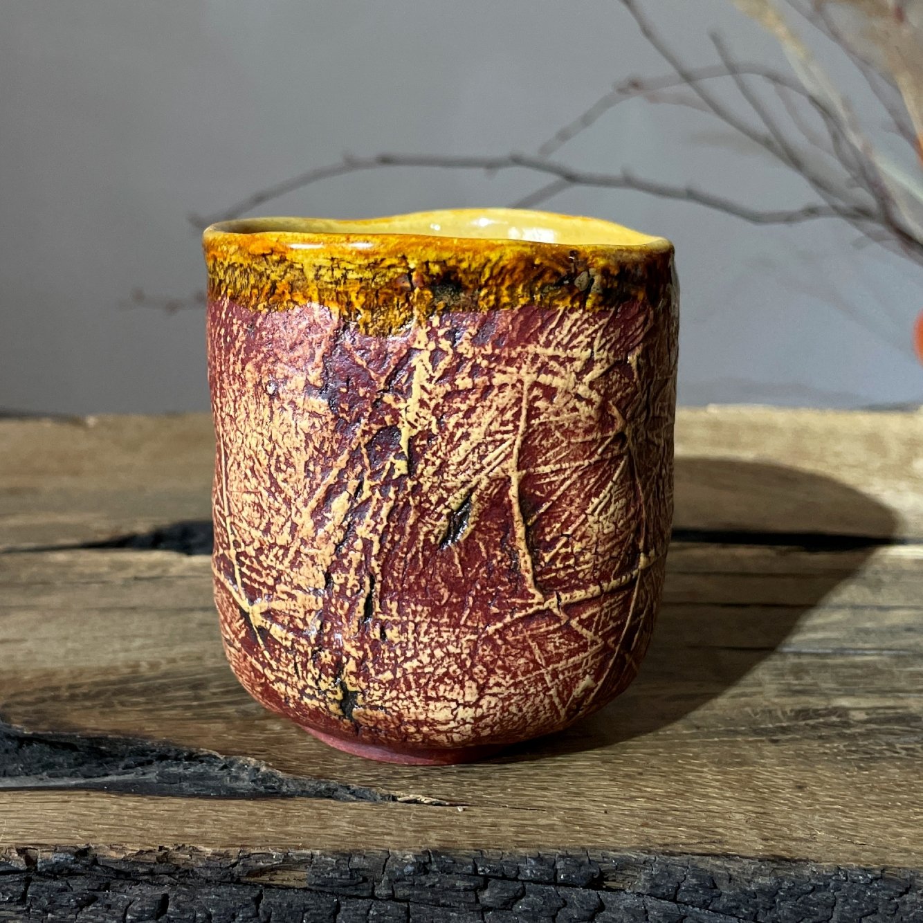 Handmade pottery tea cup with carved texture