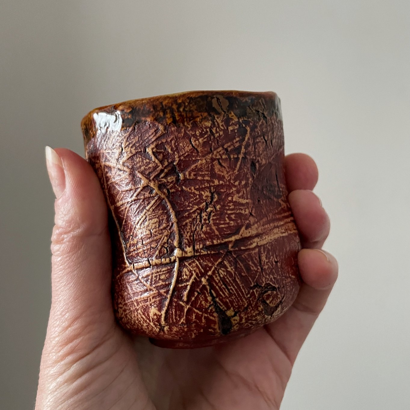 Artisan stoneware tea cup with textured finish