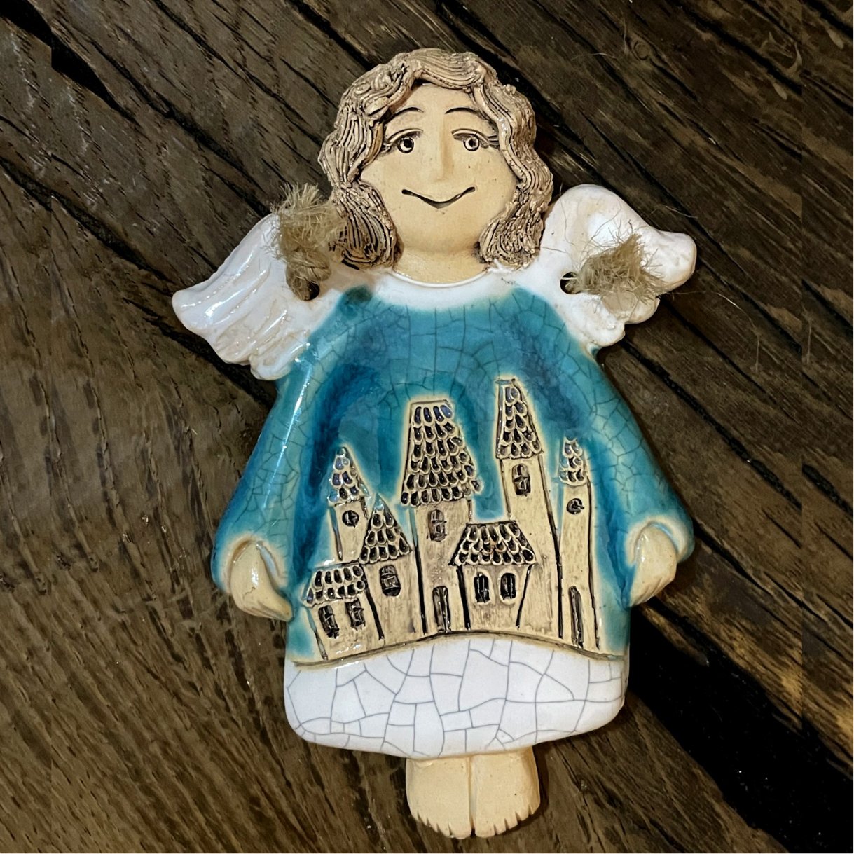 handmade blue ceramic angel with houses