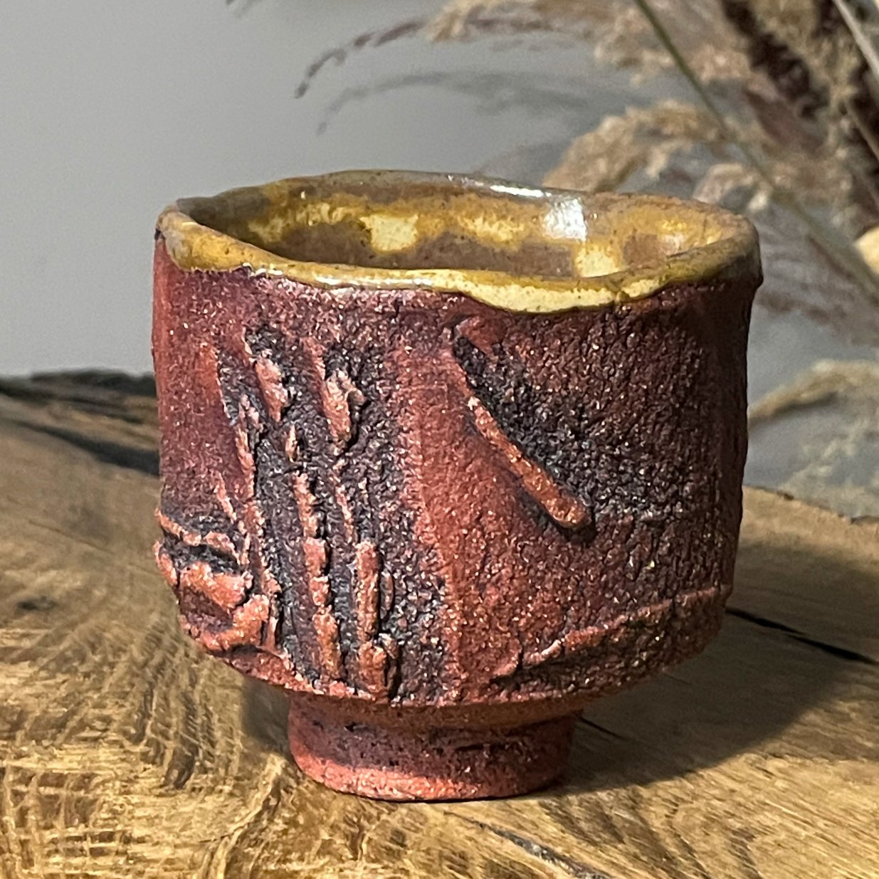 Textured kurinuki yunomi cup handmade from red stoneware