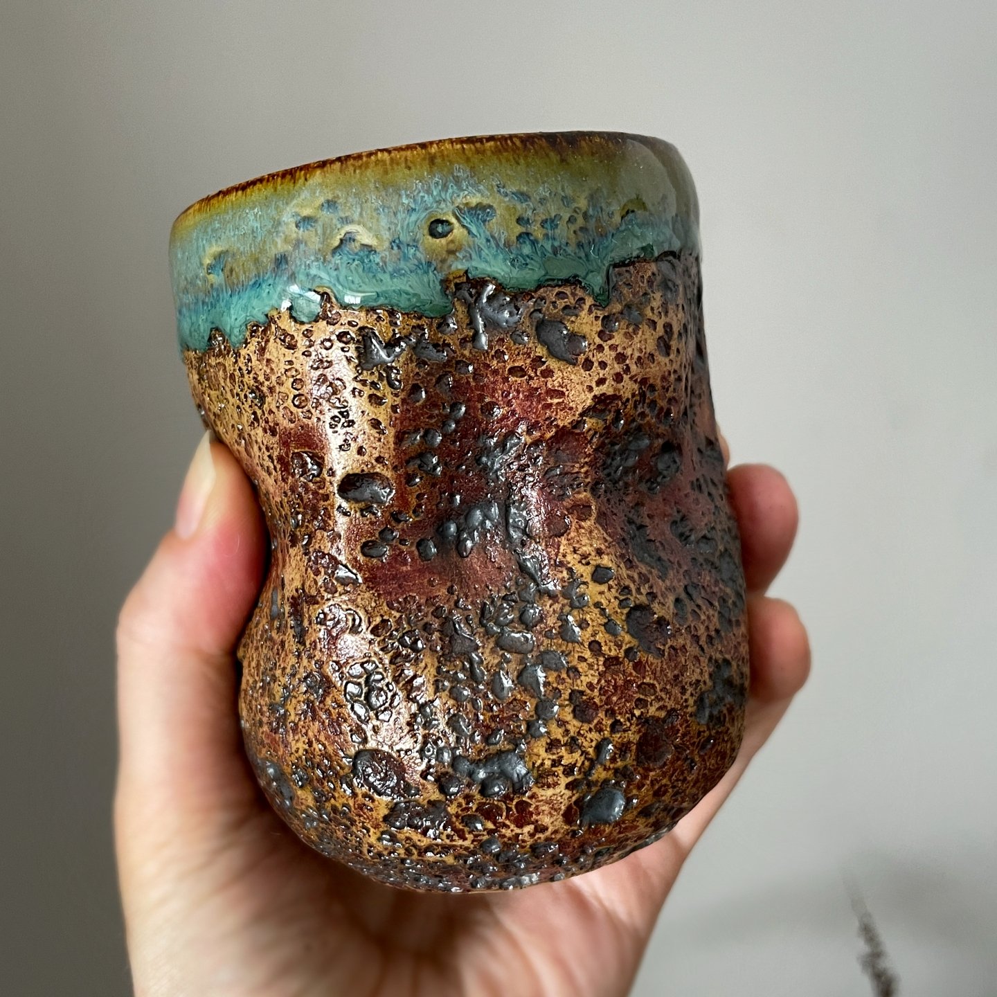 Side view of textured ceramic coffee and tea cup
